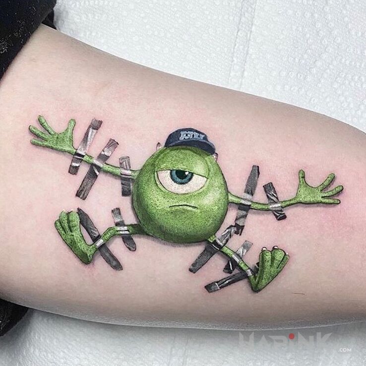 Tattoo Potwory i spółka in characters motif and cartoon / comic book style on the upper arm