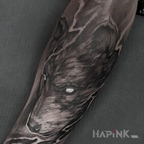 Tattoo Wolf on the forearm motif: black and gray style: sketch