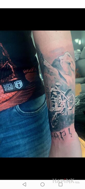 Tattoo Motocross in black and gray motif and graphic / illustrative style on the forearm