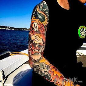 Tattoo Tiger on a yacht on the upper arm motif: sleeves style: neo-traditional