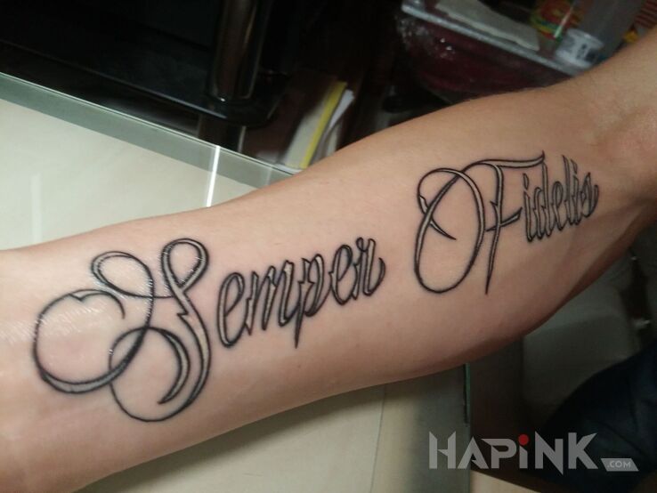 Tattoo Semper Fidelis in lettering motif on the forearm