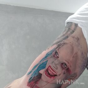 Tattoo Harley Quinn on the upper arm motif: faces style: realistic