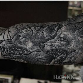 Tattoo Wolves like an engraving on the upper arm motif: black and gray style: engravings / gravure