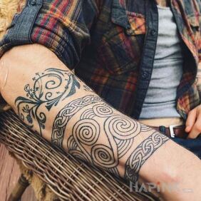 Tattoo Spiral band on the forearm motif: black and gray style: Celtic / Nordic