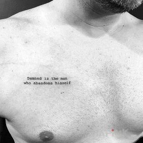 Tattoo When a Man is Cursed on the chest motif: lettering
