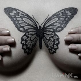 Tattoo Black butterfly on the breast motif: black and gray style: graphic / illustrative