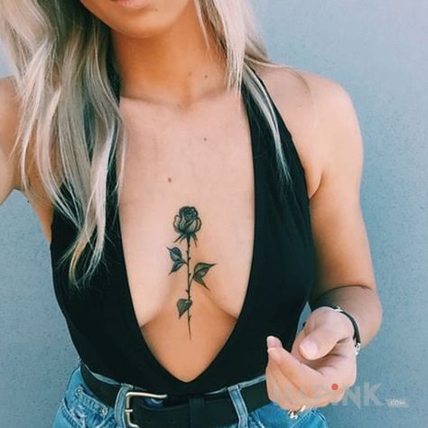 Tattoo Rozyczka in black and gray motif and graphic / illustrative style on the breast