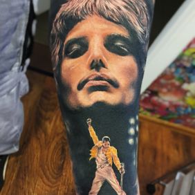 Tattoo Freddie Mercury Queen on the forearm motif: characters style: realistic