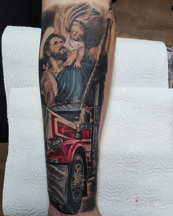 Tattoo Patron of Drivers Saint Christopher in colorful motif and realistic style On the arm