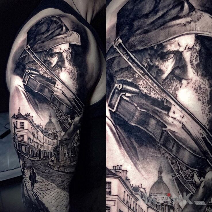 Tattoo Skrzypek in faces motif and realistic style on the upper arm