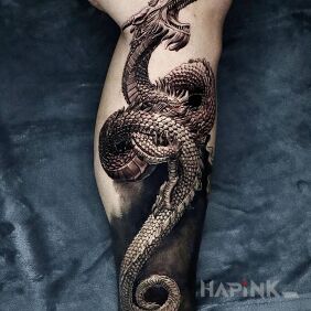 Tattoo Coiled Chinese dragon on the calf motif: black and gray style: realistic