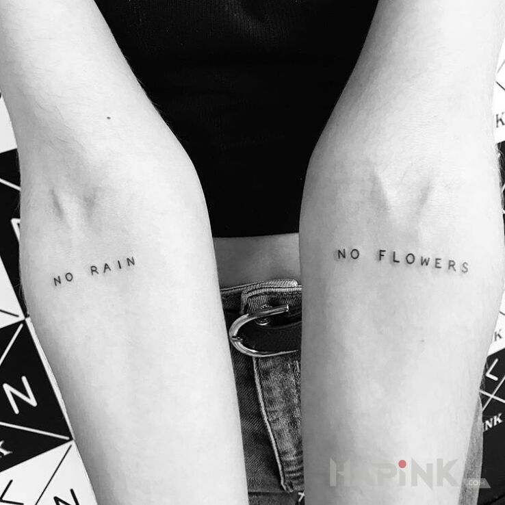 Tattoo No rain no flowers in lettering motif on the forearm
