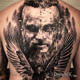 Tattoo Viking Ragnar on the back motif: black and gray style: realistic