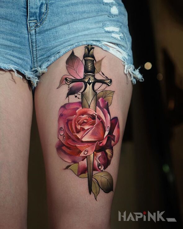 Tattoo Róża przebita sztyletem in colorful motif and neo-traditional style on the thigh
