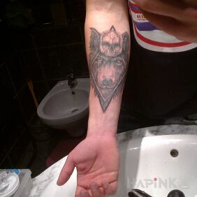 Tattoo Wild wolf, symbol of death on the forearm motif: animals style: realistic