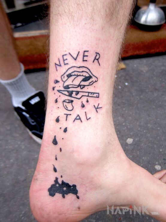 Tattoo Ucięty język in lettering motif and ignorant style near the ankle