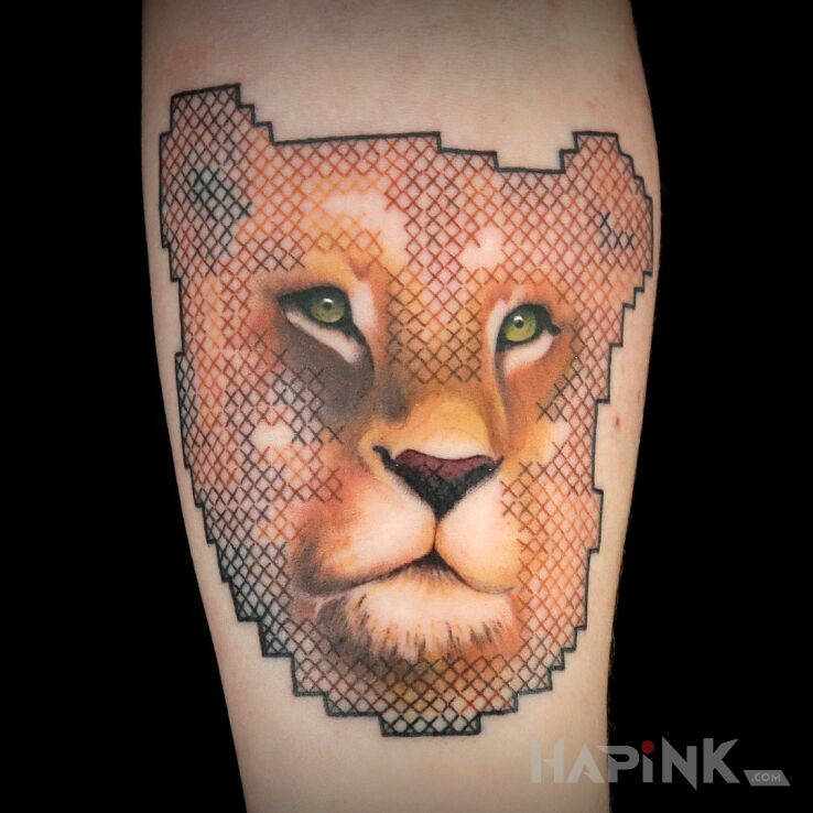 Tattoo Lwica w hafcie in animals motif and realistic style on the forearm