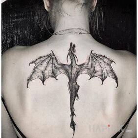 Tattoo Dragon on the back motif: black and gray style: graphic / illustrative