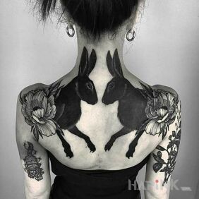 Tattoo Black rabbits On the arm motif: animals style: graphic / illustrative