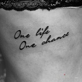 Tattoo One life one chance on the ribs motif: lettering style: calligraphy