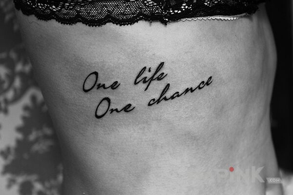 Tattoo One life one chance in lettering motif and calligraphy style on the ribs