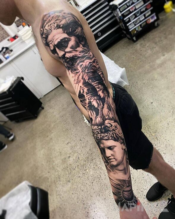 Tattoo Starożytne klimaty in faces motif and realistic style On the arm