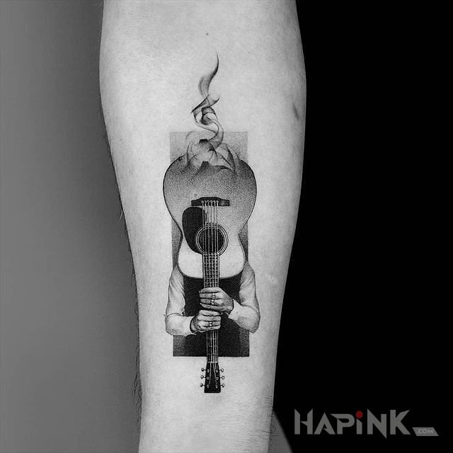 Tattoo Schowany za gitara in black and gray motif and graphic / illustrative style on the forearm