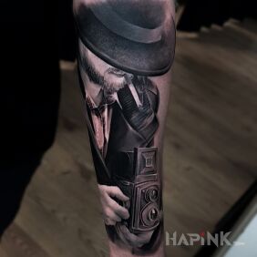 Tattoo Photographer On the arm motif: characters style: realistic