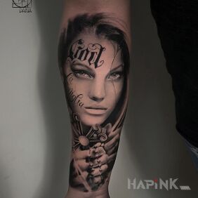 Tattoo Portrait of a woman On the arm motif: black and gray style: realistic