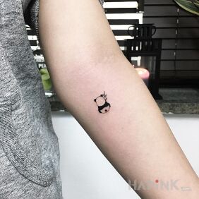 Tattoo Mini panda ? on the forearm motif: animals style: minimalistic