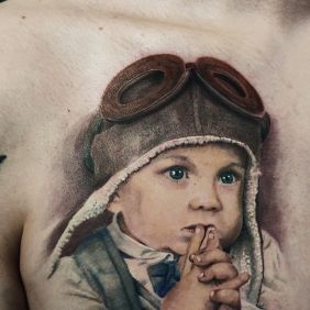 Tattoo Child portrait on the chest motif: colorful style: realistic