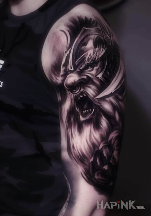 Tattoo Odyn in war motif and realistic style On the arm