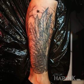 Tattoo ... Wings on the leg motif: black and gray style: graphic / illustrative