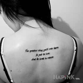 Tattoo About love on the back motif: lettering