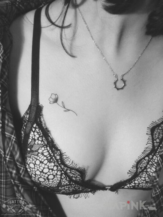 Tattoo Mini mini kwiat in black and gray motif and minimalistic style on the breast