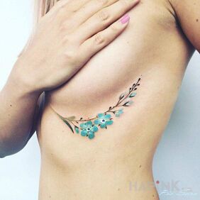 Tattoo Branch with flowers on the ribs motif: flowers style: realistic