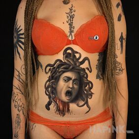 Tattoo Head of Medusa on the stomach motif: black and gray style: realistic