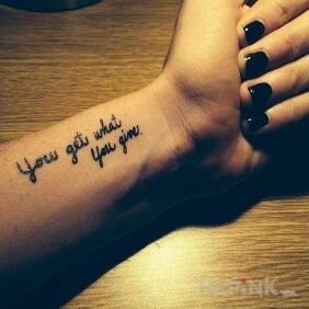 Tattoo You get what you give on the forearm motif: lettering