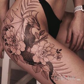 Tattoo Floral Dragon on the thigh motif: black and gray style: graphic / illustrative