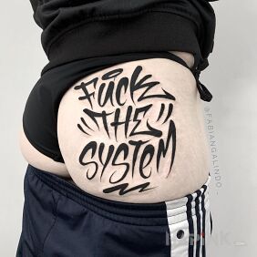 Tattoo Fuck the system on the buttocks motif: lettering style: graffiti