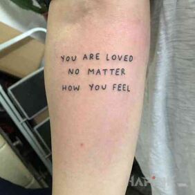Tattoo You are loved on the forearm motif: lettering