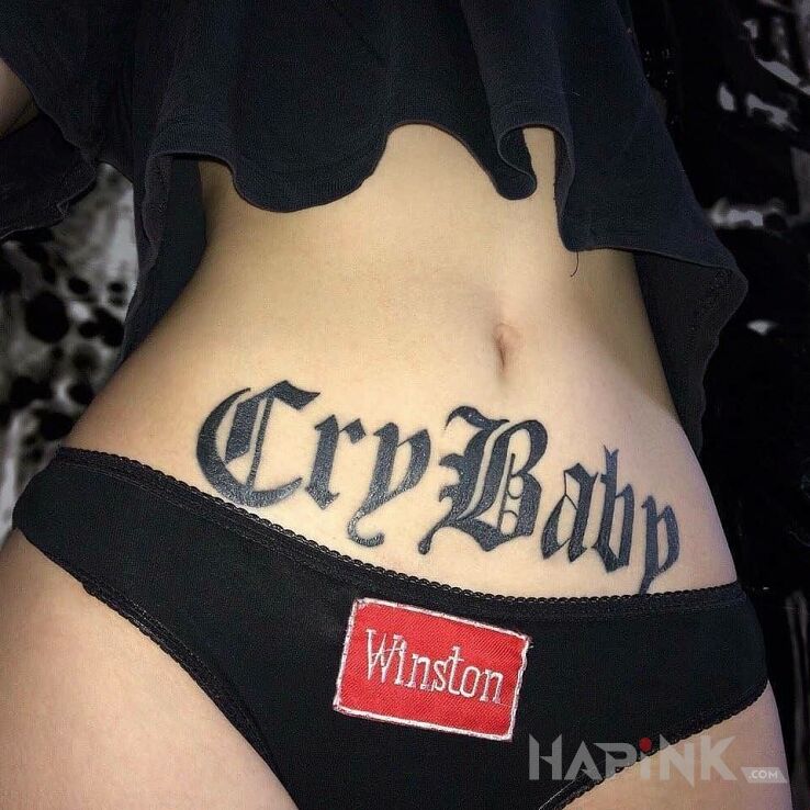Tattoo Cry Baby in lettering motif on the stomach