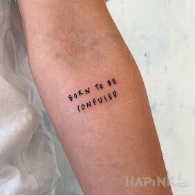 Tattoo Born to be confused on the forearm motif: lettering style: ignorant