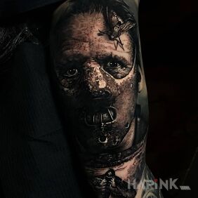 Tattoo Dark Hannibal Lecter on the upper arm motif: insects style: realistic