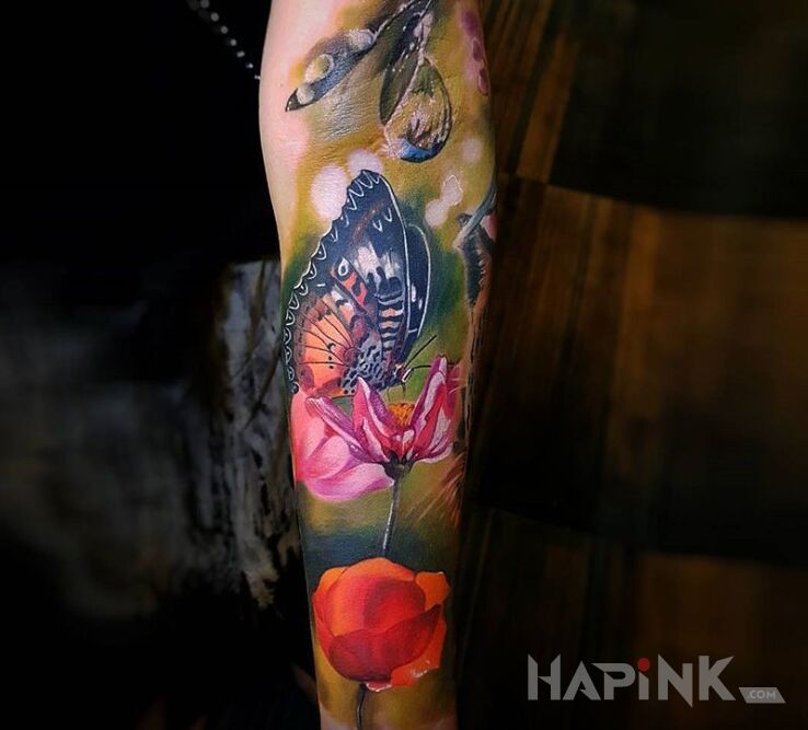 Tattoo Motylek na kwiatku in butterflies motif and realistic style on the forearm