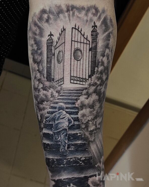 Tattoo Gates of Heaven in religious motif and realistic style On the arm