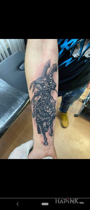 Tattoo Husaria in animals motif and realistic style On the arm