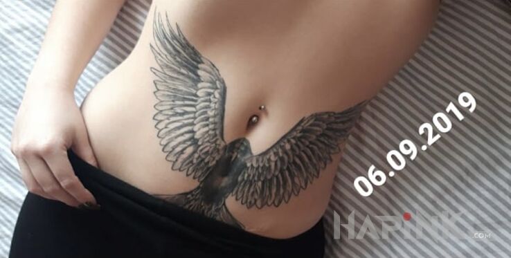Tattoo Orzeł na brzuchu in wings motif and realistic style on the stomach