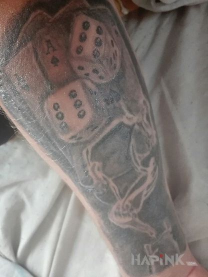 Tattoo Karty i kości in objects motif and realistic style On the arm