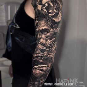Tattoo Greek god on the upper arm motif: black and gray style: realistic